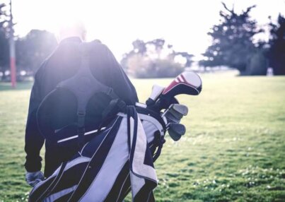 person-walking-a-golf-course-carrying-golf-bag-2
